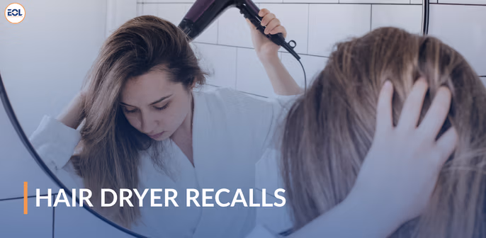 Woman using a hair dryer in front of a mirror, with text overlay "HAIR DRYER RECALLS," highlighting concerns about safety issues related to hair dryer recalls, particularly the Bliss brand.