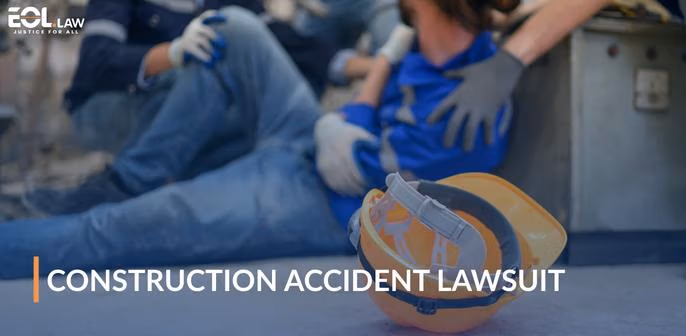 Construction accident scene with injured worker receiving assistance, hard hat in foreground, emphasizing legal support for crane accident lawsuits.