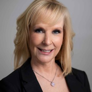 Professional headshot of Lisa A., paralegal at Ethen Ostroff Law, smiling and wearing a black blazer, with a light background.